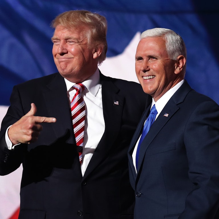 Donald Trump stands next to Mike Pence, pointing at him.
