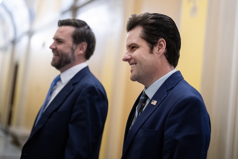 Matt Gaetz is seen in profile while walking next to JD Vance