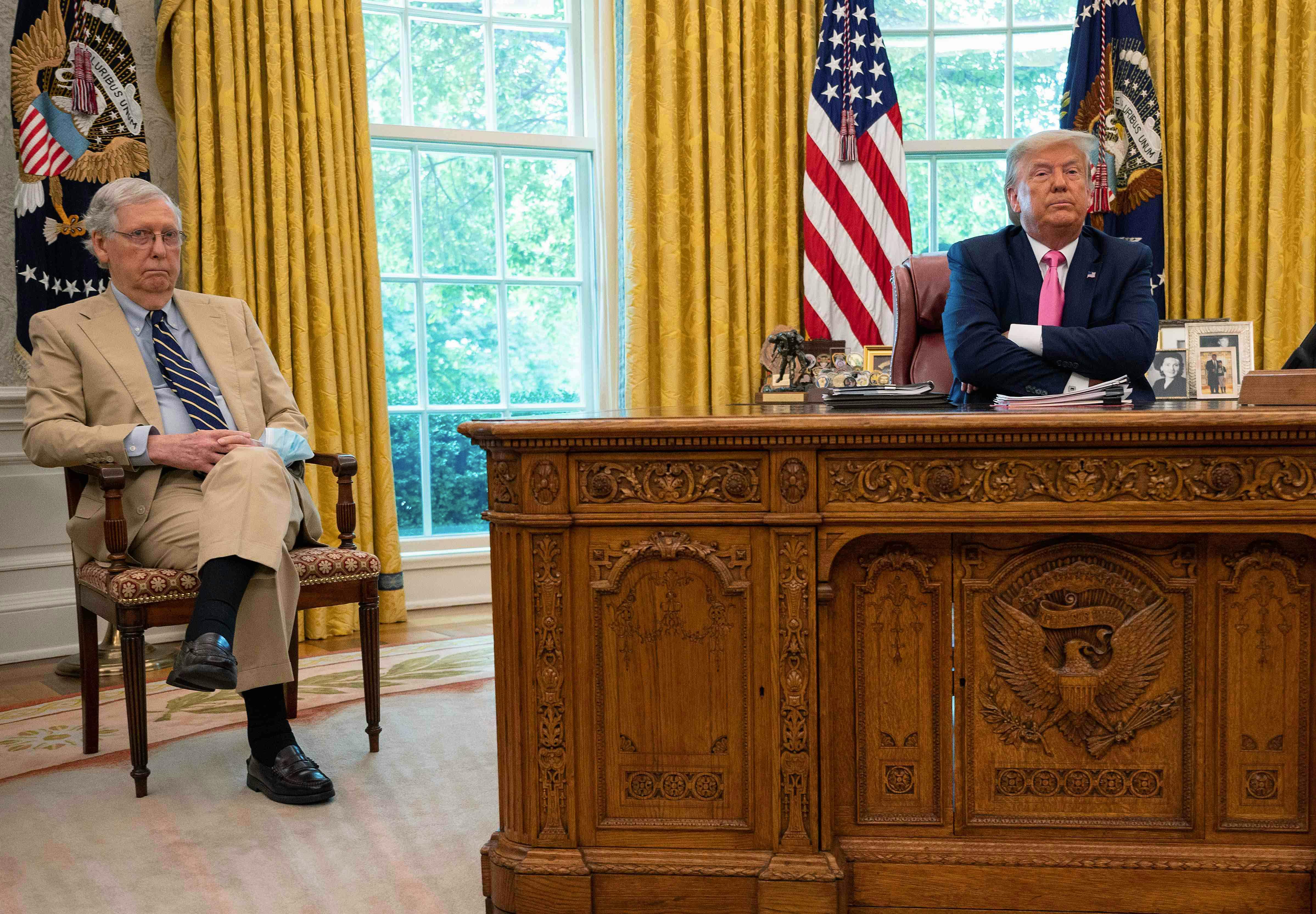 President Donald Trump speaks with Senate Majority Leader Mitch McConnell in the Oval Office. 