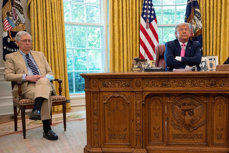 President Donald Trump speaks with Senate Majority Leader Mitch McConnell in the Oval Office. 