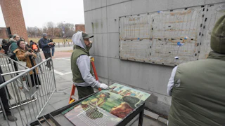 Staff with the National Parks Service replace the plaques that were part of the “Freedom and Slavery in the Making of a New Nation” exhibit at the President’s House