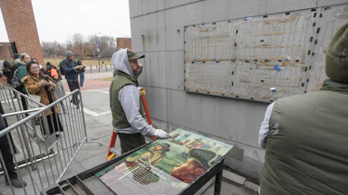 Staff with the National Parks Service replace the plaques that were part of the “Freedom and Slavery in the Making of a New Nation” exhibit at the President’s House