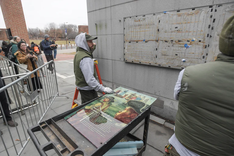 Staff with the National Parks Service replace the plaques that were part of the “Freedom and Slavery in the Making of a New Nation” exhibit at the President’s House
