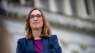 Sarah McBride crosses her arms outside the Capitol.