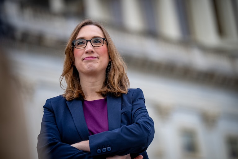 Sarah McBride crosses her arms outside the Capitol.