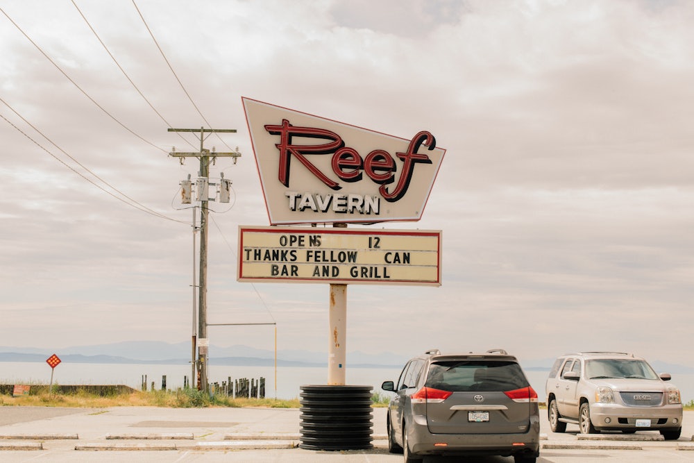 A photograph of the exterior of Kiniski’s Reef Tavern and the parking lot in Point Roberts, Washington