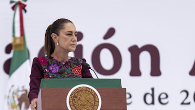 Mexican President Claudia Sheinbaum speaks at a podium.