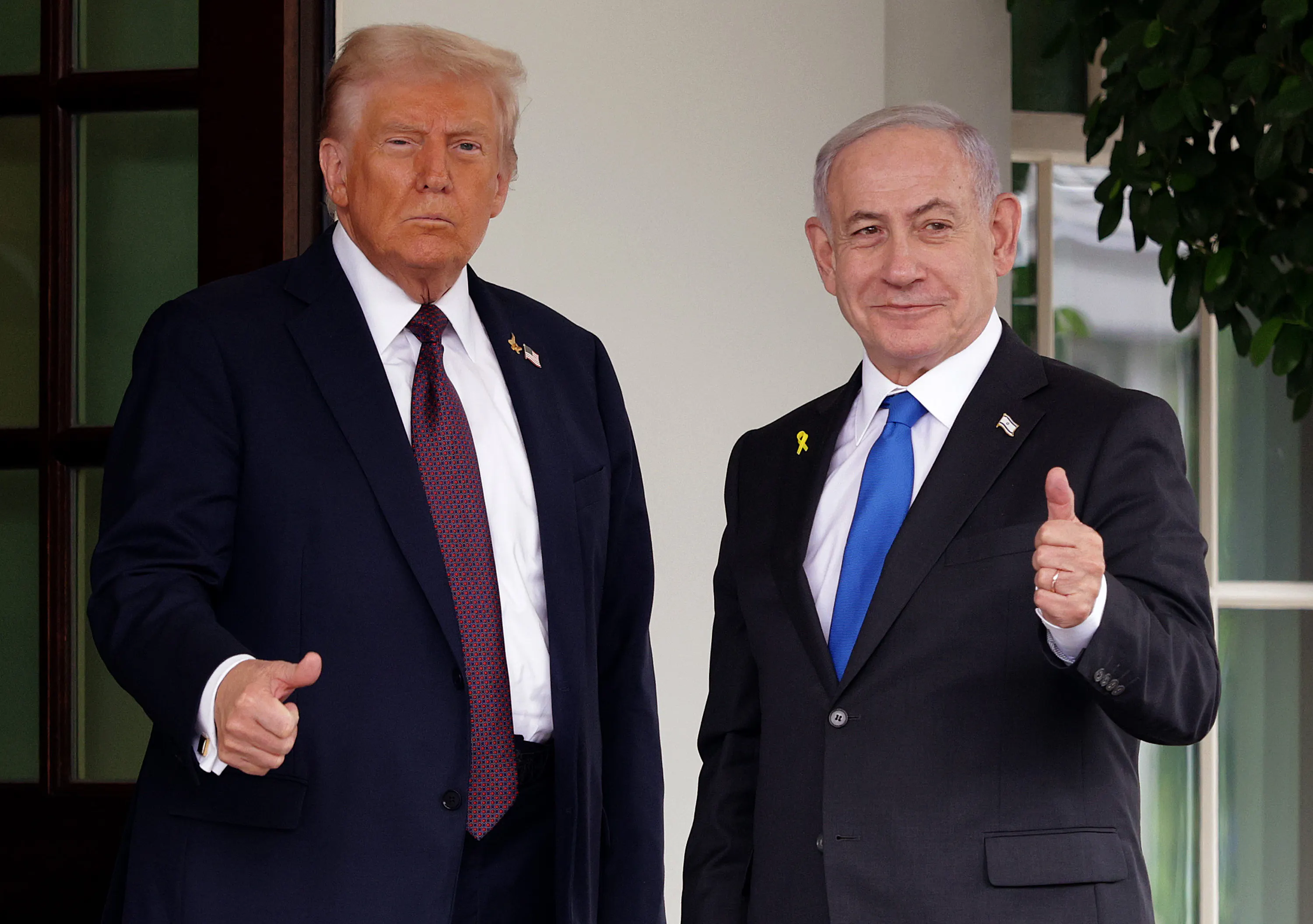 U.S. President Donald Trump and Israeli Prime Minister Benjamin Netanyahu both give a thumbs up outside the White House.
