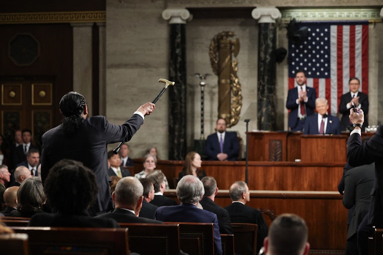 Representative Al Green shakes his cane at Donald Trump as he delivers his address to a joint session of Congress.