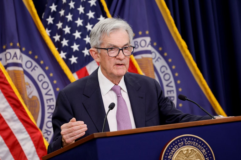 Federal Reserve Chair Jerome Powell stands at a podium and speaks to reporters