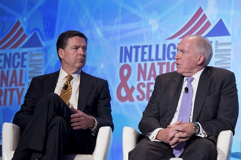 FBI Director James Comey (L) and CIA Director John Brennan speak at the 2016 Intelligence and National Security Summit in Washington, D.C.