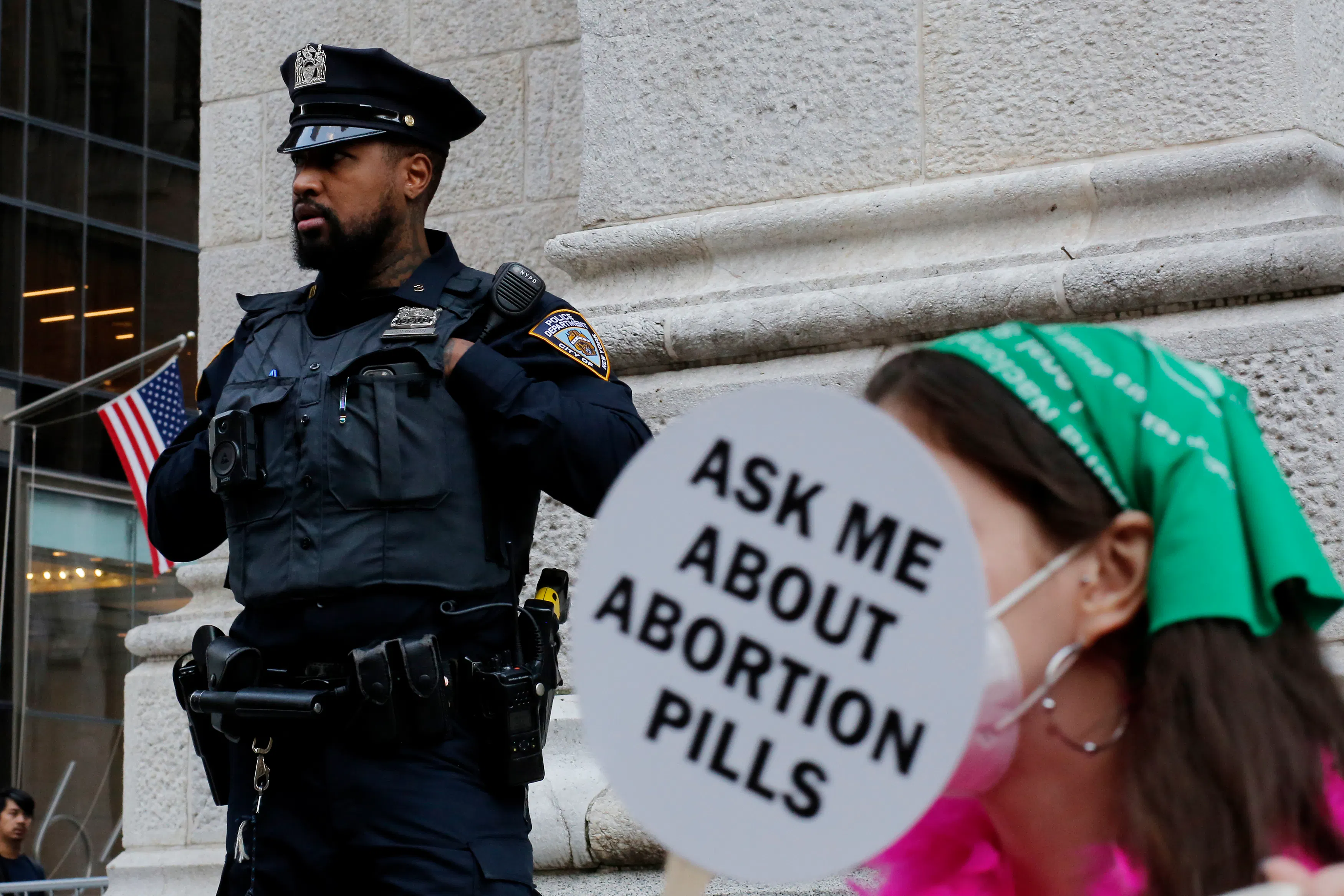 A police officer watched activists during the Abortion Carnival at St. Patrick’s Cathedral in New York City in 2022, months after the Supreme Court tore down Roe v. Wade. 