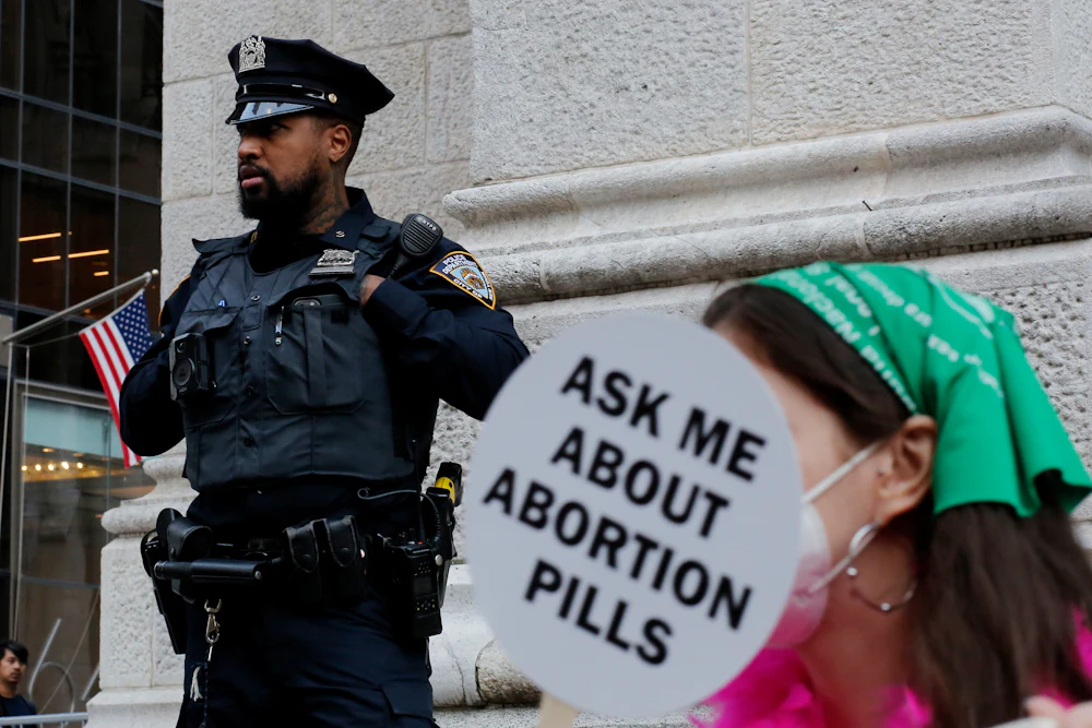 A police officer watches activists during an "abortion carnival" at St. Patrick’s Cathedral in New York City in 2022, months after the Supreme Court tore down Roe v. Wade.
