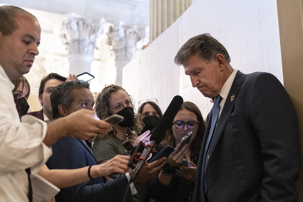 Joe Manchin talks to reporters during the “vote-a-rama” on the Inflation Reduction Act.