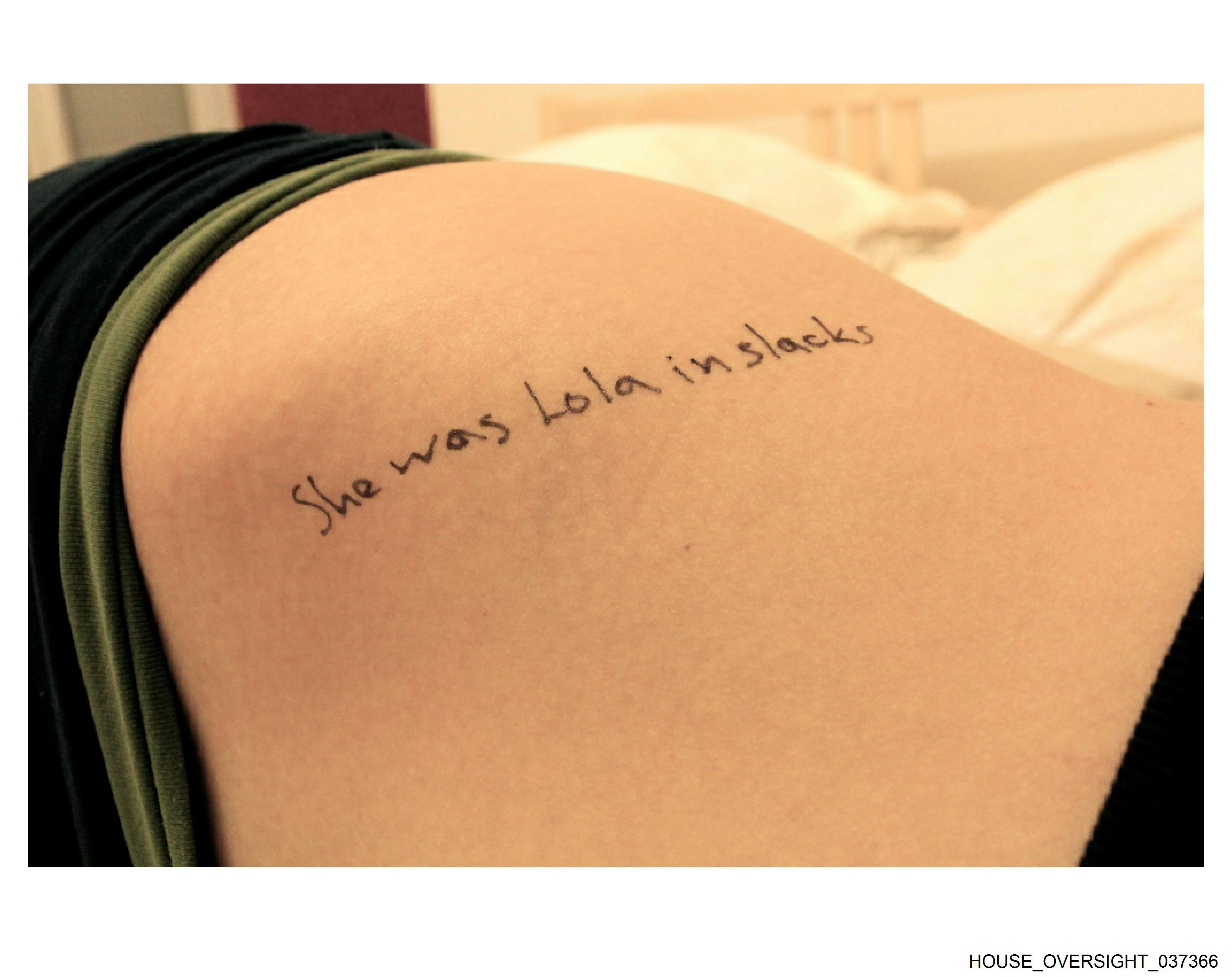 "She was Lola in slacks" written on a part of a girl's body (unclear)