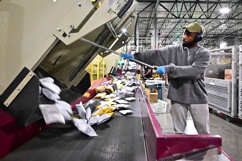 A postal worker sorts through mail and packages at the Los Angeles processing and distribution center.