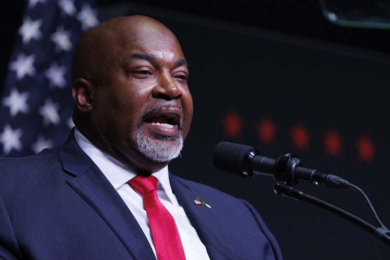 Mark Robinson speaks into a microphone