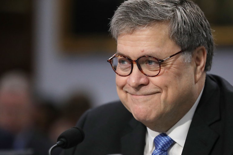 Attorney General William Barr smirks at a hearing.