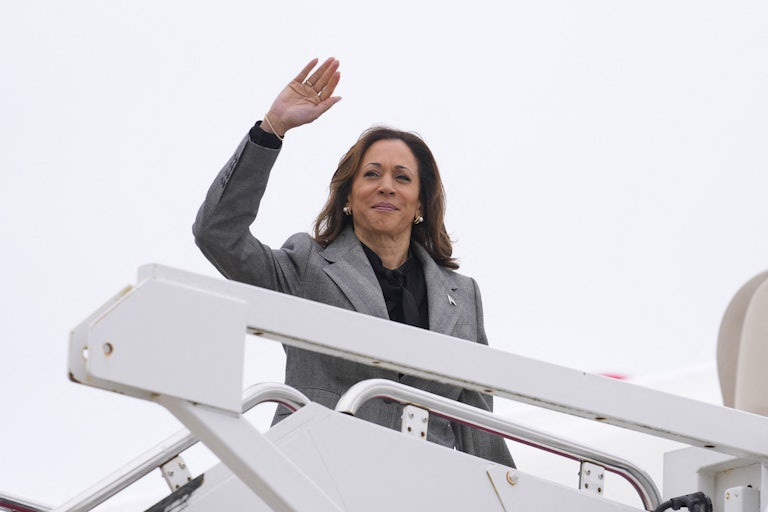 Kamala Harris waves while boarding Air Force Two