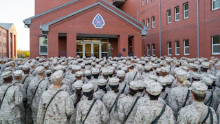Marine recruits listen to someone speaking