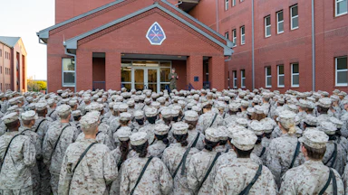 Marine recruits listen to someone speaking