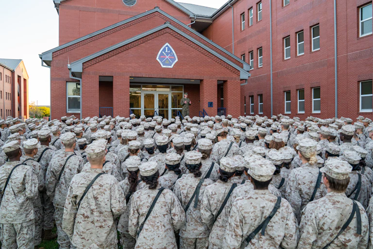 Marine recruits listen to someone speaking