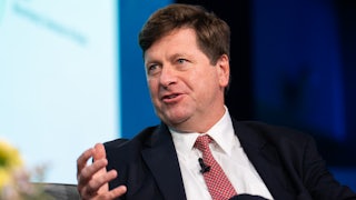 U.S. Attorney for the Southern District of New York Jay Clayton gestures and speaks while sitting on stage during an event