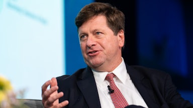 U.S. Attorney for the Southern District of New York Jay Clayton gestures and speaks while sitting on stage during an event