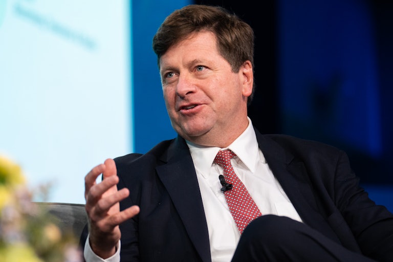 U.S. Attorney for the Southern District of New York Jay Clayton gestures and speaks while sitting on stage during an event