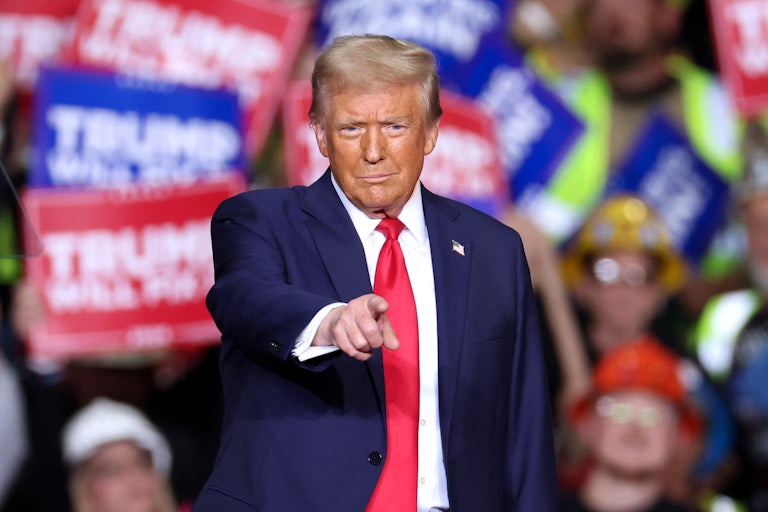 Donald Trump points at the audience during a campaign event