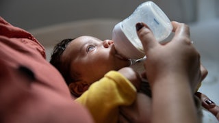 infant being bottle fed 