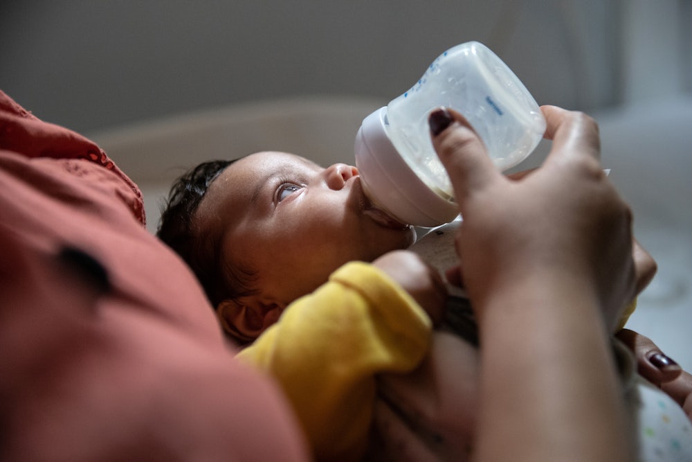 infant being bottle fed