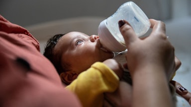 infant being bottle fed