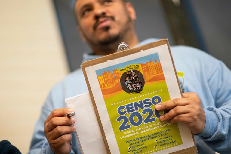 An organizer holds documents for the 2020 census.