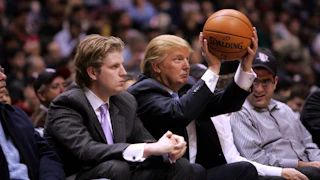Trump sitting next to his son Eric displays whack shooting form