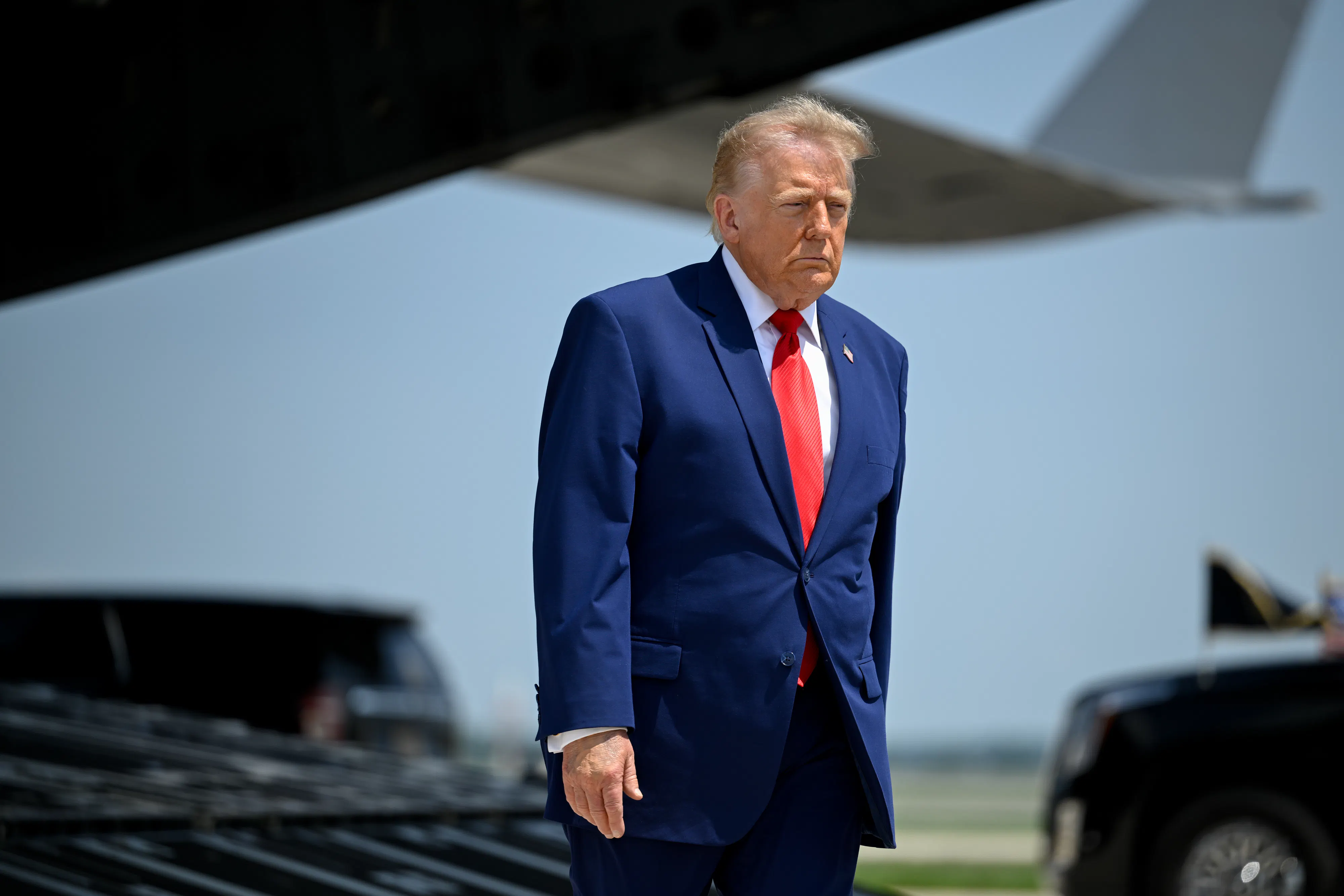 Donald Trump stands during the dignified transfer of soldiers in Delaware.
