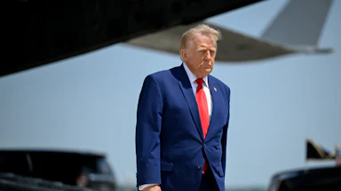 Donald Trump stands during the dignified transfer of soldiers in Delaware.