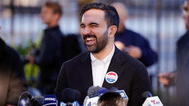 Zohran Mamdani laughs at a press conference