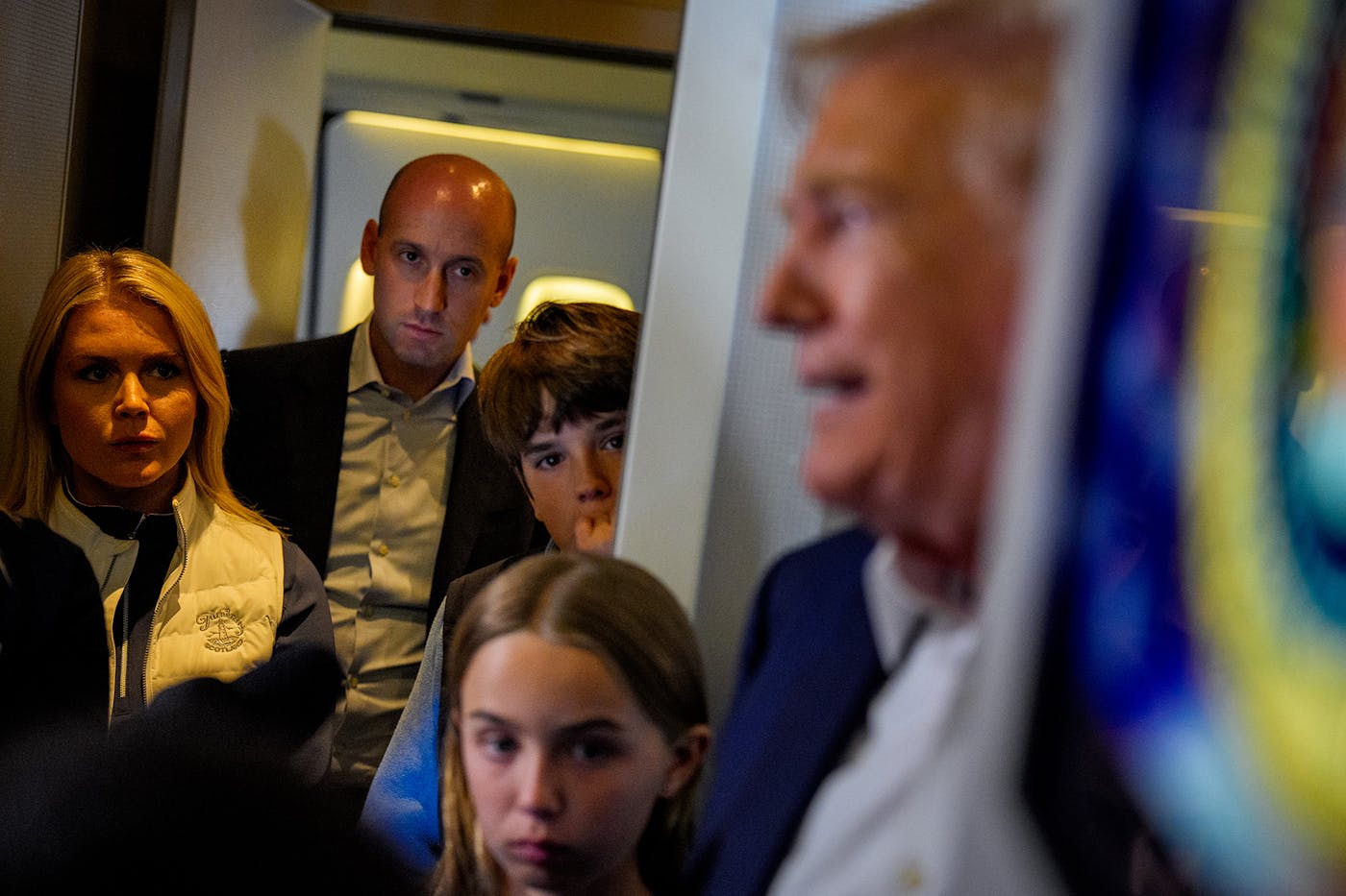 Miller watched as Trump spoke to reporters aboard Air Force One last July.