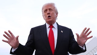 President Donald Trump speaks with both hands in the air.