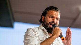 Brandon Herrera speaks aggressively into a microphone
