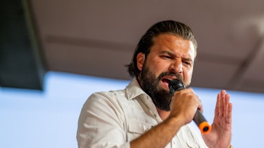 Brandon Herrera speaks aggressively into a microphone