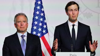 Jared Kushner gestures while standing at a podium. Steve Witkoff stands to his right.