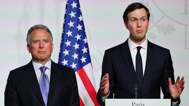 Jared Kushner gestures while standing at a podium. Steve Witkoff stands to his right.