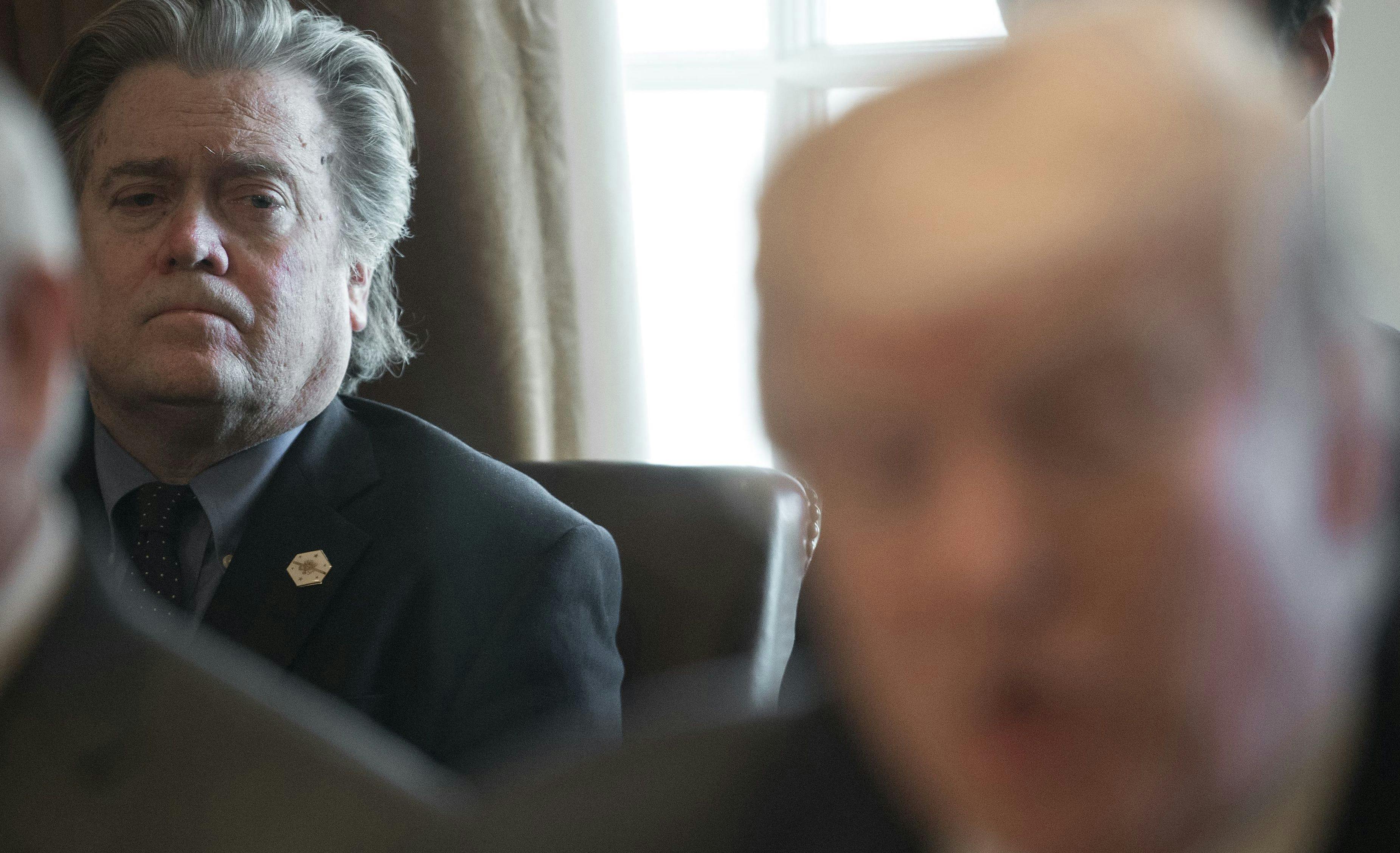 Steve Bannon listens to Trump at a Cabinet meeting