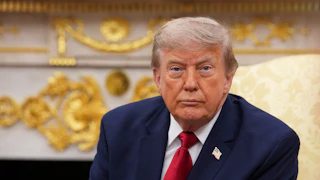 Donald Trump stares listelessly while sitting