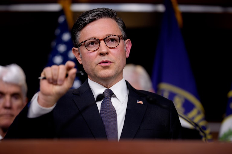 House Speaker Mike Johnson speaks at a podium.