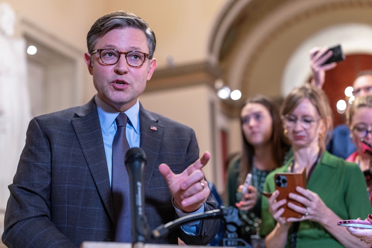 House Speaker Mike Johnson speaks in the Capitol as he's surrounded by reporters.