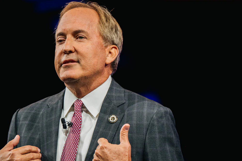 Ken Paxton gestures with hands while talking