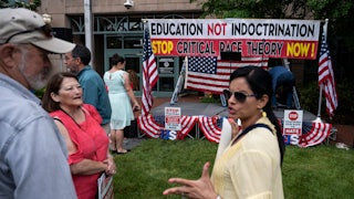 People talk before the start of a rally against "critical race theory" in Loudoun County, Virginia.